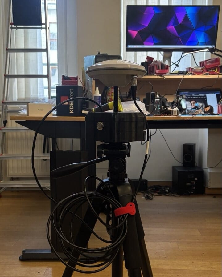 Side view of the assembled base station on its tripod, with antenna cable.